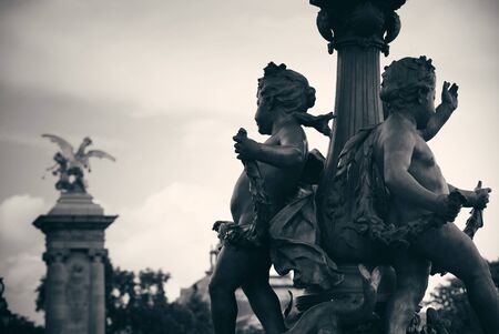 Vintage statue on Alexandre III bridge over River Seine in Paris, France.の写真素材