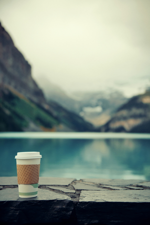 Lake Louise with coffee cup in Banff national park with mountains and forest in Canada.の写真素材