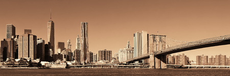 Manhattan financial district with skyscrapers and Brooklyn Bridge.の写真素材