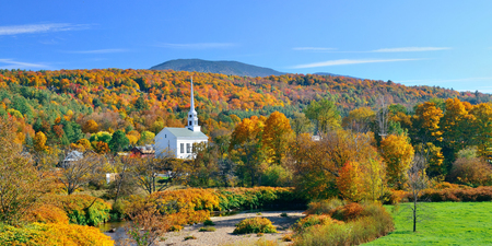 Stowe panorama in Autumn with colorful foliage and community church in Vermontの写真素材
