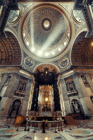 St. Peter's Basilica interior with light beam in Vatican City.のeditorial素材