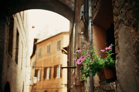 Street view with old buildings and archway in Siena, Italy.の写真素材