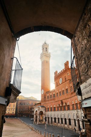 City Hall Bell Tower viewed from archway in Siena Italy.の写真素材