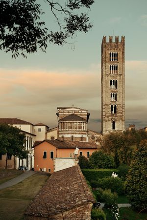 Basilica di San Frediano in Lucca with historic buildings at dusk in Italy.の写真素材