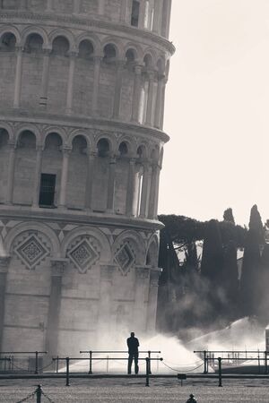 Leaning tower and man in morning in Pisa, Italy as the worldwide known landmark.の写真素材