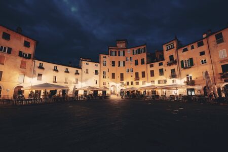 Piazza dell Anfiteatro in Lucca Italy night viewの写真素材