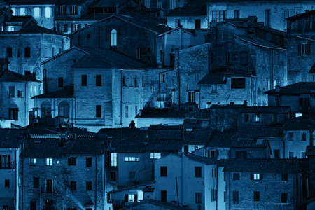 Old building background at night from Siena, Italy.の写真素材