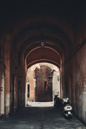 Street view with old buildings and archway in Siena, Italy.の写真素材