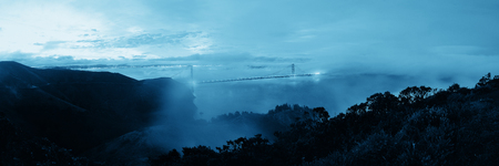 Golden Gate Bridge and fog panorama in San Francisco viewed from mountain topの写真素材