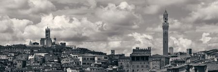 Siena Cathedral and Torre del Mangia Bell Tower with historic buildings. Italyの写真素材
