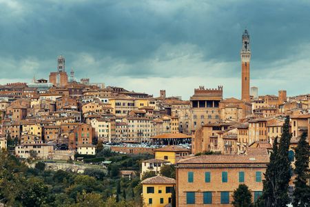 Siena Cathedral and Torre del Mangia Bell Tower with historic buildings. Italyの写真素材