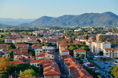 Pisa city viewed from the leaning tower at sunset in Italyの写真素材