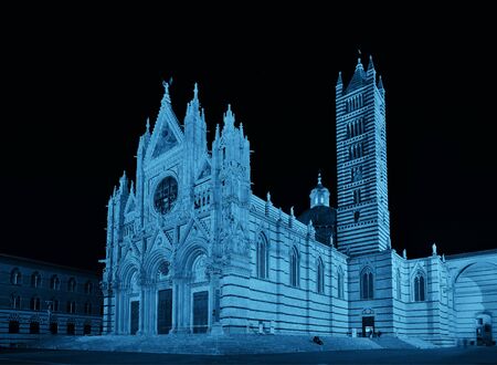 Siena Cathedral closeup as the famous landmark in medieval town at night in Italy.の写真素材