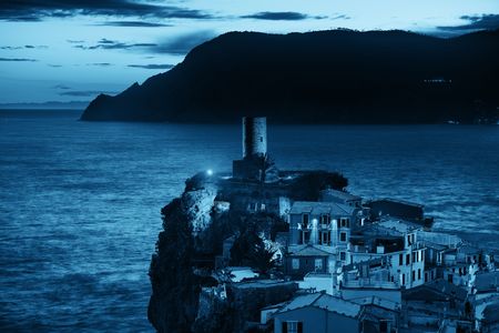 Vernazza with buildings on rocks over sea in Cinque Terre, Italy.の写真素材