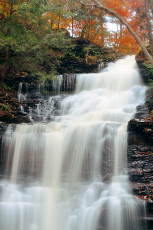 Autumn waterfalls in park with colorful foliage.の写真素材