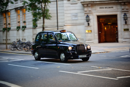 LONDON, UK - SEP 27: Vintage taxi in street on September 27, 2013 in London, UK. London is the world's most visited city and the capital of UK.のeditorial素材