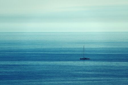 A lonely boat in Mediterranean Sea with abstract backgroundの写真素材