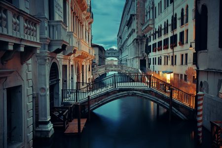 Venice canal view at night with bridge and historical buildings. Italy.の写真素材