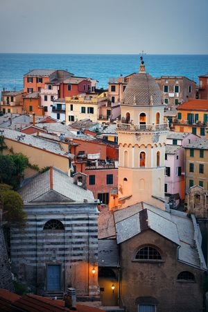 Vernazza with buildings on rocks over sea in Cinque Terre, Italy.の写真素材