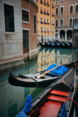 Gondola park in water in Venice canal with historical buildings. Italy.の写真素材