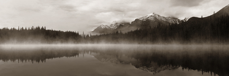 Lake Herbert panorama in a foggy morning with glaciers mountain and reflection in Banff National Park, Canadaの写真素材