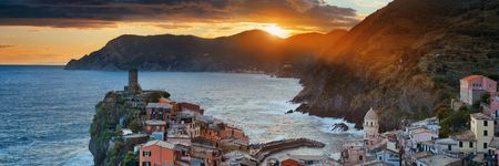 Colorful sunset in Vernazza with buildings on rocks over sea in Cinque Terre, Italy.の写真素材