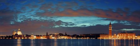 Venice skyline at night with Santa Maria della Salute church and clock tower historical architectures panorama in Italy.の写真素材