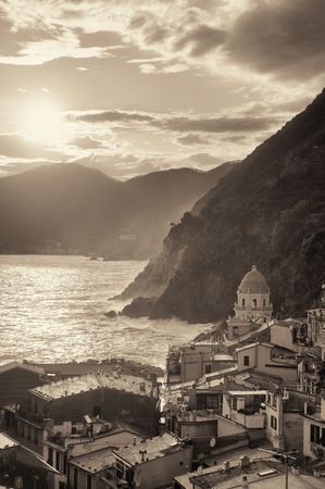 Vernazza with buildings on rocks over sea black and white in Cinque Terre, Italy.
