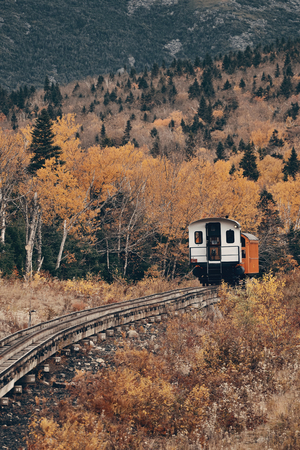 MT Washington, NEW HAMPSHIRE - OCT 13: Tourism train at mountain range with foliage on October 13, 2015 in New Hampshire. Mt Washington is the highest peak in Northeastern America.のeditorial素材