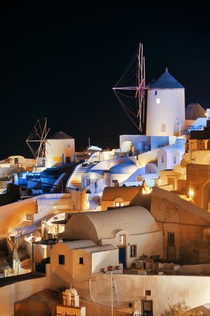 Santorini skyline at night with buildings and windmill in Greece.の写真素材