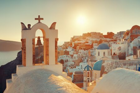 Santorini skyline sunset with church bell and buildings in Greece.の写真素材