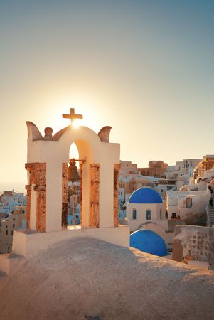 Santorini skyline sunset with church bell and buildings in Greece.の写真素材