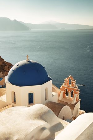 Santorini skyline with blue dome church and buildings in Greece.の写真素材