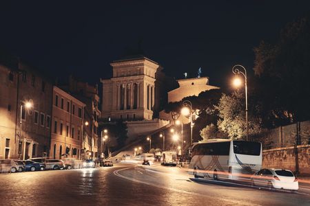 Street view at night with National Monument to Victor Emmanuel II in Rome, Italy. のeditorial素材