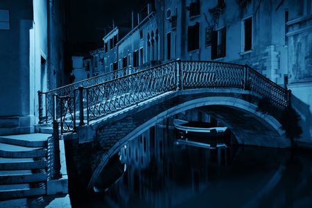 Venice canal view at night with bridge and historical buildings. Italy.の写真素材