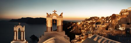 Santorini skyline at night with buildings and bell tower in Greece.の写真素材