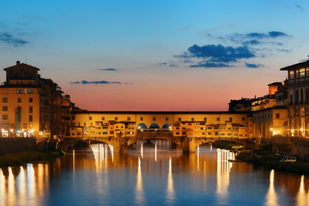 Ponte Vecchio over Arno River in Florence Italy at night.の写真素材