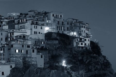 Italian style resident buildings over cliff in Manarola in Cinque Terre at night, Italy.の写真素材