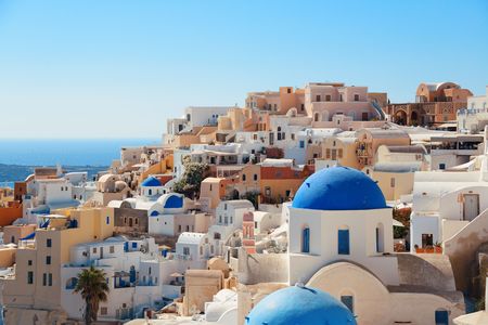 Santorini skyline with blue dome church and buildings in Greece.の写真素材