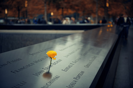 NEW YORK CITY - NOV 12: September 11 memorial with rose on November 12, 2014 in Manhattan, New York City. With population of 8.4M, it is the most populous city in the United States.のeditorial素材