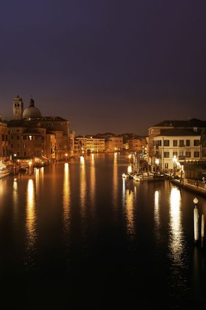 Venice canal view at night with historical buildings. Italy.の写真素材
