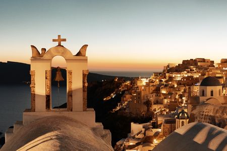 Santorini skyline at night with buildings and bell tower in Greece.の写真素材