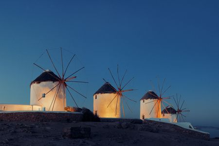 Windmill as the famous landmark at night in Mykonos Island, Greece.