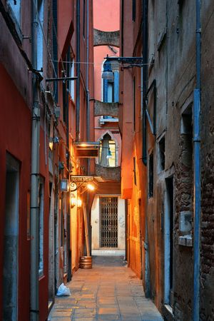 Alley view with historical buildings at night in Venice, Italy.の写真素材