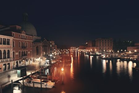 Venice canal view at night with historical buildings. Italy.