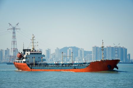 Boat and Xiamen city skyline in Fujian, China.の写真素材