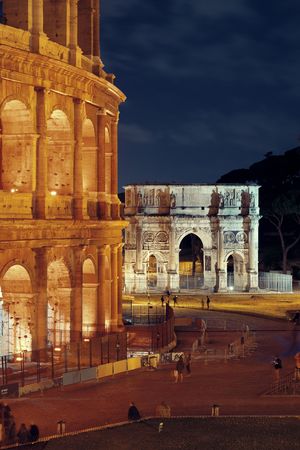 Arch of Constantine and Colosseum at night in Rome, Italy.の写真素材