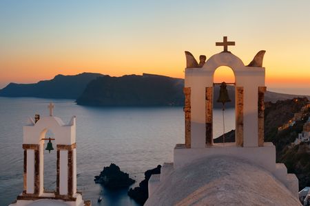 Santorini skyline at night with buildings and bell tower in Greece.の写真素材