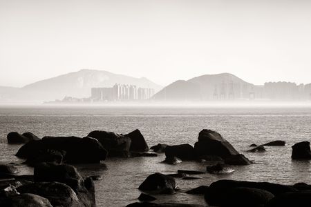 Xiamen city skyline and rock at shore in Fujian, China.の写真素材