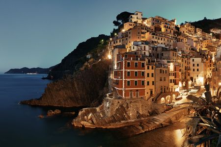 Riomaggiore waterfront view with buildings in Cinque Terre at night, Italy.の写真素材